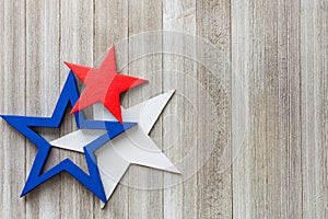 Wooden red, white and blue stars on a rustic background with copy space/4th of July background concept