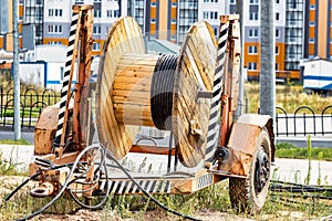 Wooden reel with high voltage cable mounted on a trailer for easy transport and stowage. Laying a high-voltage power cable in the