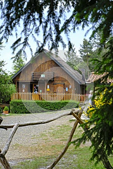 wooden refuge building across the fir-tree branches. Rural life. Vacation in the countryside. Monte Fuso, Parma