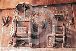 Wooden relief carvings depict umbrellas and chairs