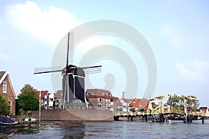 Rembrandt bridge and windmill De Put in Leiden photo