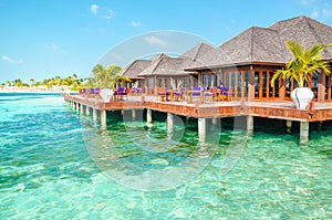 A wooden restaurant on the water against the backdrop of the azure waters of the Indian Ocean, Maldives