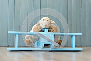Wooden retro airplane model and sheep toy over retro vintage bro