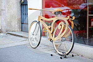 Wooden retro bicycle parked on the street of Milan. Exploring a city center. Milan, Italy