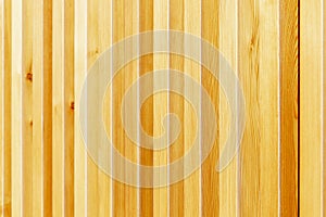 Wooden ribbed surface with vertical lines in sunlight. Close-up. Space for text. Background