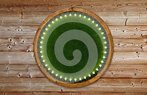 Wooden ring light frame with green grass backdrop