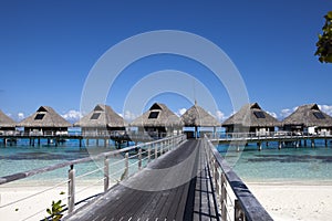 The wooden road over the sea to traditional lodges on piles