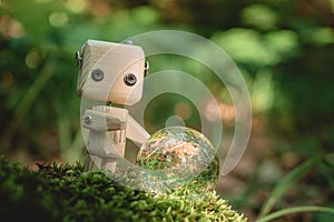 wooden robot looks into a crystal ball