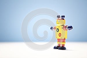 Wooden robot toy background artificial intelligence or childhood concept