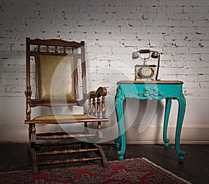 Wooden rocking chair, green vintage table and old telephone set