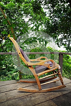 Wooden rocking chair on the terrace of a ecological forest cottage in Minca, Sierra Nevada de Santa Marta Mountain photo