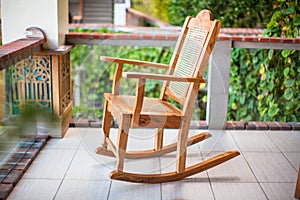 Wooden rocking chair on the terrace of an exotic photo