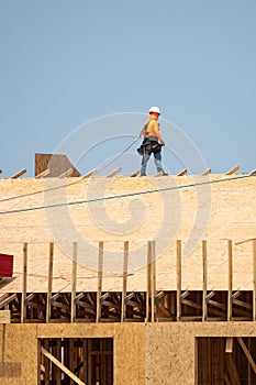 Wooden roof beam from framework. House roof at construction site. Roofer working on roof structure of building on