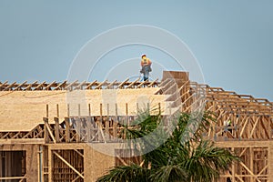 Wooden roof beam from framework. House roof at construction site. Roofer working on roof structure of building on