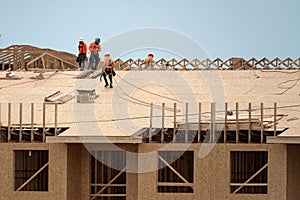 Wooden roof beam from framework. House roof at construction site. Roofer working on roof structure of building on