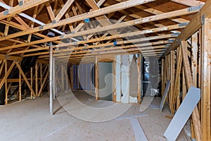 Wooden roof beams with insulates the attic with pipe heating system and mineral wool