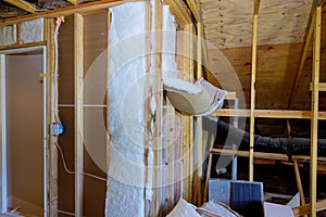 Wooden roof beams with insulates the attic with pipe heating system and mineral wool