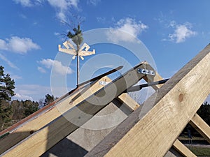 Wooden roof construction. symbolic panicle at the end of house construction
