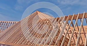 Wooden roof truss framing under construction in new home