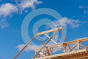 Wooden roof truss framing under construction in new home