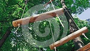 Wooden rope stairs moving slowly in a children climbing adventure park