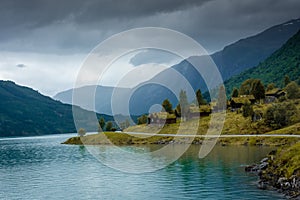 Wooden rorbus, typical houses with grass on the roof, on the Lovatnet Lake,  Norway