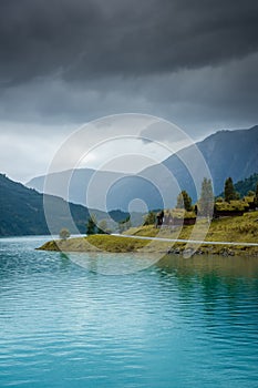 Wooden rorbus, typical houses with grass on the roof, on the Lovatnet Lake,  Norway