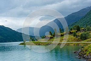 Wooden rorbus, typical houses with grass on the roof, on the Lovatnet Lake,  Norway