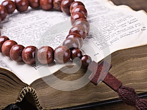 Wooden rosary and the Bible