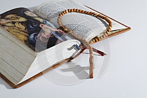 Wooden rosary on a Bible