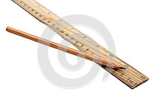 Wooden ruler and pencil on white background