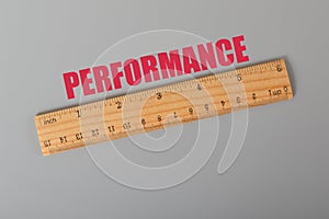 Wooden ruler with text PERFORMANCE. Performance concept