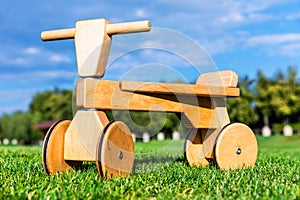 Wooden runbike on the grass field outdoors