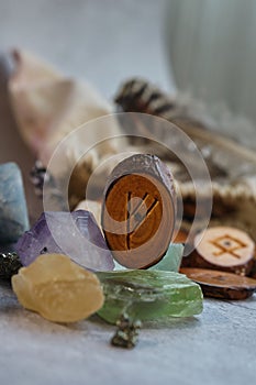wooden rune of the fehu among the crystals photo
