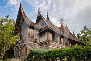 Wooden rural house with an unusual roof in the village of the Minangkabau people on the island of Sumatra