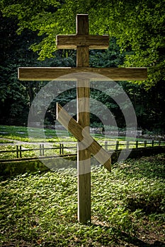A wooden Russian orthodox cross in the forest.