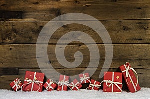 Wooden rustic background with red christmas presents.