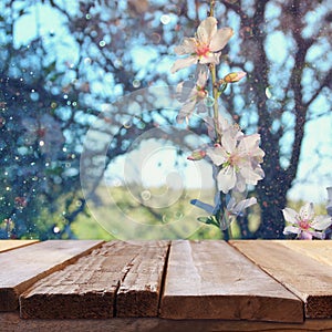 wooden rustic table in front of spring cherry tree