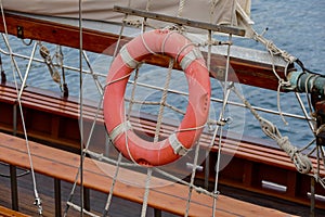 Wooden sailboat on the blue mediterranean sea Details of a classic beautiful sailing yacht with ropes knots and wood plank on deck