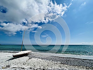 Wooden sailboat on trailer on the beach