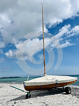 Wooden sailboat on trailer on the beach