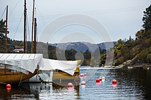 Wooden sailboats stand at the dock