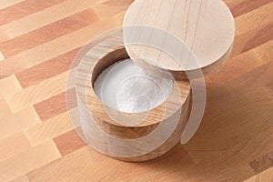 Wooden salt box on wood cutting board