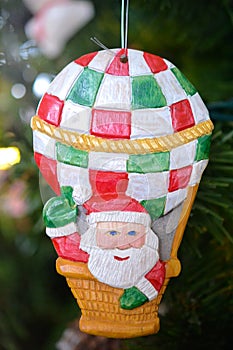 Wooden Santa Claus in a Balloon Christmas Ornament on a Tree