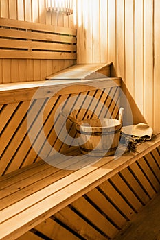 Wooden sauna cabin with sauna accessories