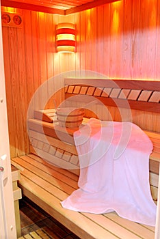 Wooden sauna interior with towel