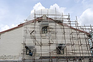 Wooden scaffold on house, renovation. Scaffolding on building, wall and window. Scaffolding system in construction , Singapore