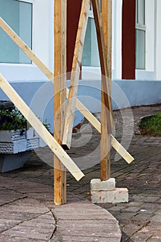 wooden scaffolding with bricks, laid under the foot for the worker plasterer. reportage. safety violation.