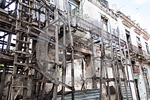 Wooden scaffolding holding a dilapidated building in Havana, Cuba