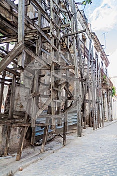 Wooden scaffolding holding a dilapidated building in Havana, Cuba